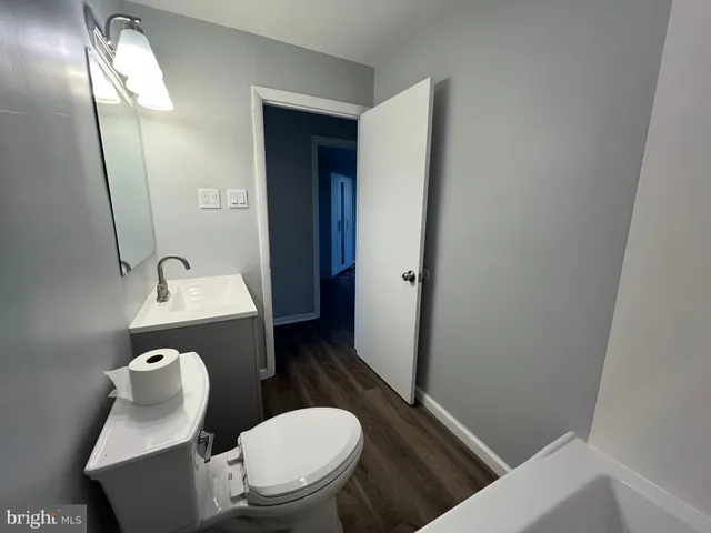 a bathroom with a toilet a sink a mirror and a shower