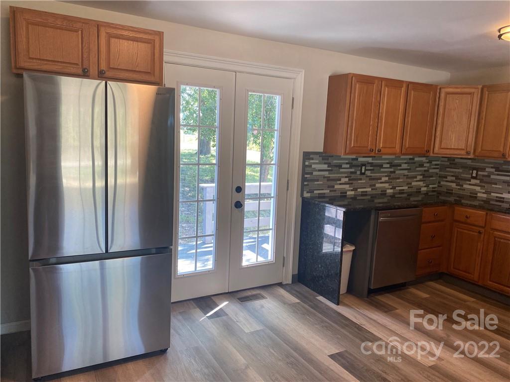 1911 Beacon Road Lancaster, SC 29720 - Photo 6 of 19 a kitchen with granite countertop a refrigerator and a stove top oven