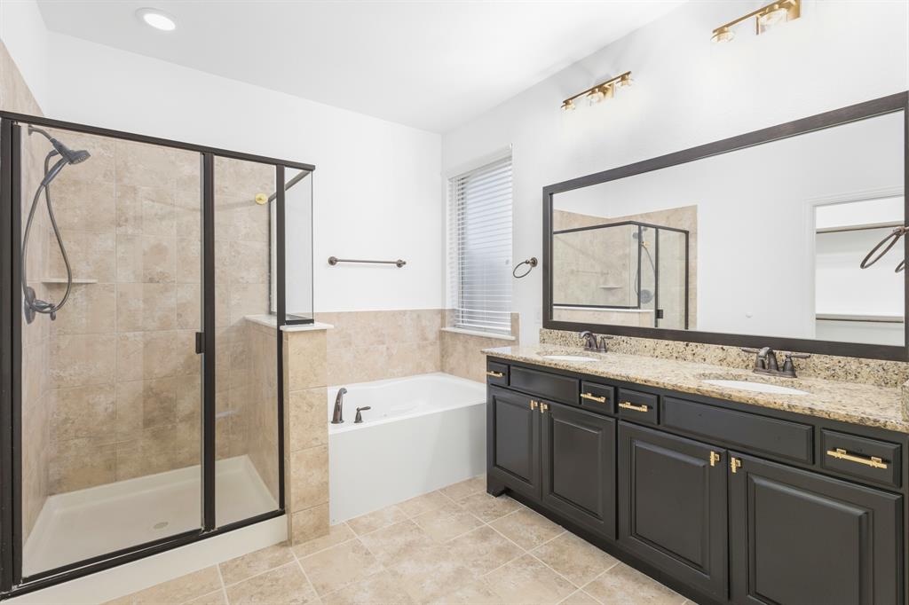 1995 Verde Court Allen, TX 75013 - Photo 13 of 30 Spacious bathroom featuring a frameless glass shower enclosure, a separate soaking tub, and a double vanity with stone countertops