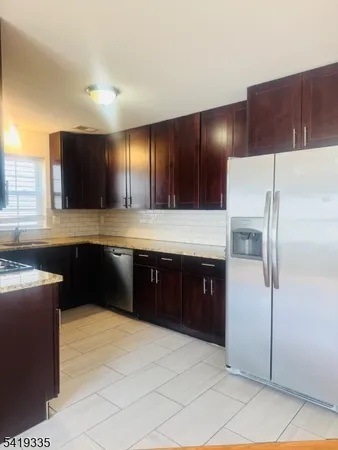 a kitchen with a refrigerator and a sink