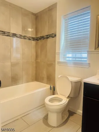 a bathroom with a toilet and a bathtub