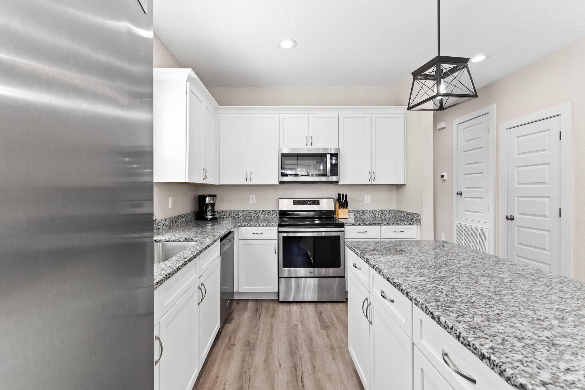 22 Mobile Street Miramar Beach, FL 32550 - Photo 19 of 55 a kitchen with kitchen island granite countertop a sink stove and refrigerator