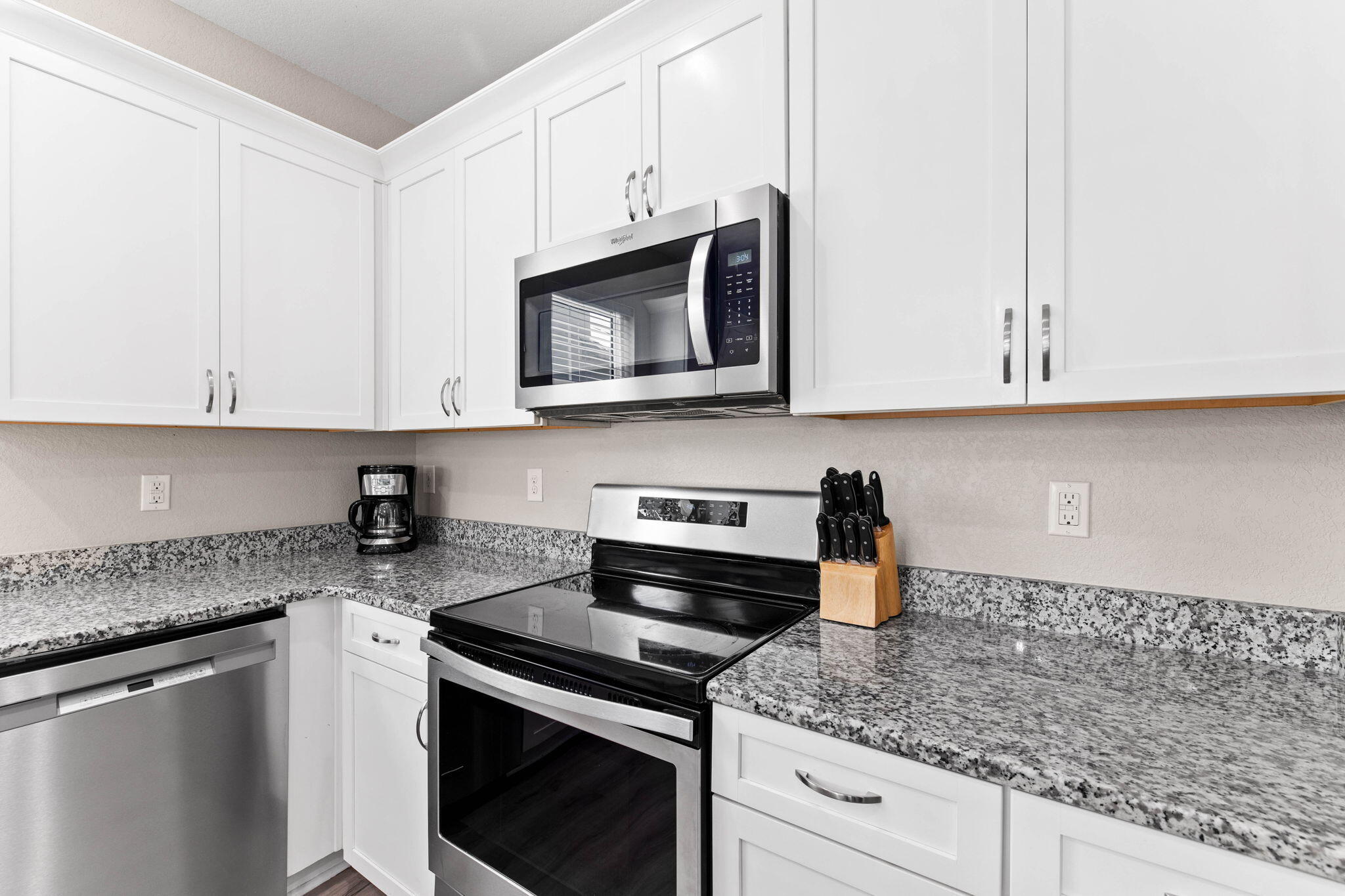 22 Mobile Street Miramar Beach, FL 32550 - Photo 20 of 55 a kitchen with stainless steel appliances granite countertop white cabinets and a stove top oven