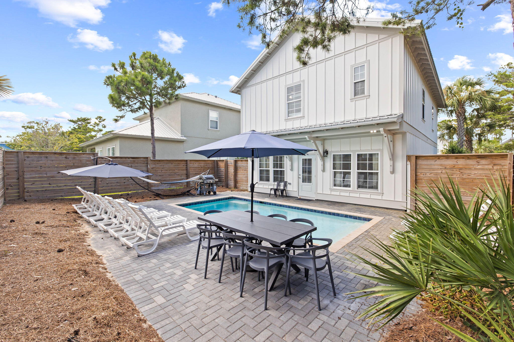 22 Mobile Street Miramar Beach, FL 32550 - Photo 45 of 55 a view of a patio with table and chairs and potted plants