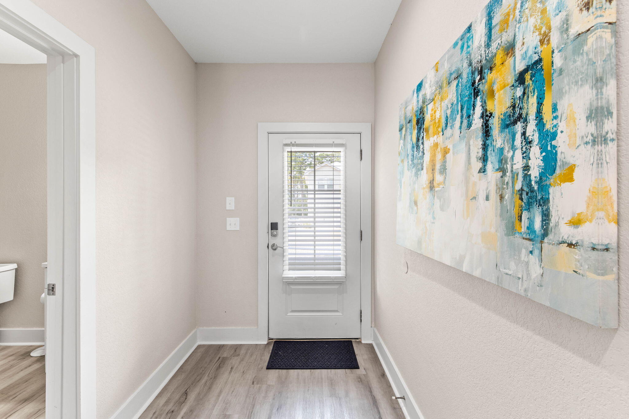 22 Mobile Street Miramar Beach, FL 32550 - Photo 8 of 55 a view of a hallway with wooden floor and a bathroom