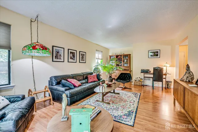 a living room with furniture or couch and a wooden floor