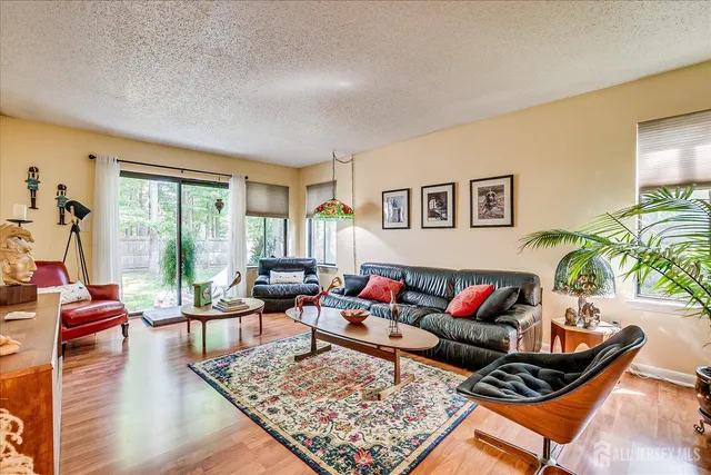 a living room with furniture couches and a large window