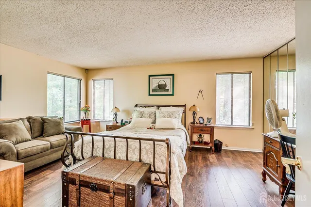 a bedroom with furniture and a wooden floor