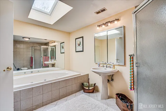 a bathroom with a sink mirror and a bathtub
