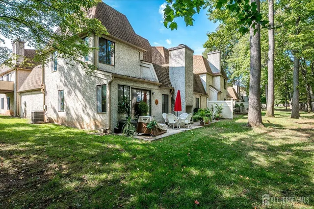a view of a house with backyard and sitting area