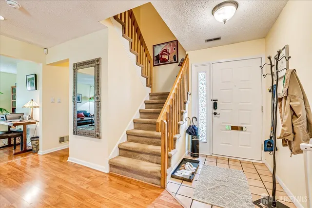 a view of an entryway with wooden floor and door