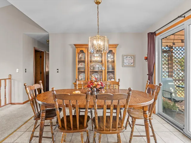 a dining room with furniture a chandelier and wooden floor