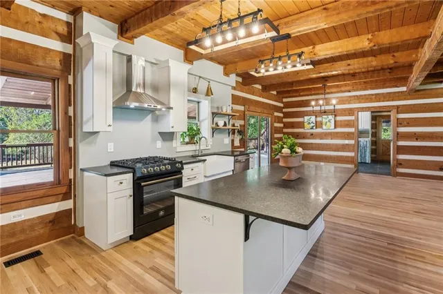 a kitchen with stainless steel appliances granite countertop a stove a sink and a refrigerator