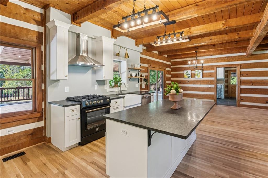 2905 Cammie Wages Road Dacula, GA 30019 - Photo 11 of 55 a kitchen with stainless steel appliances granite countertop a stove a sink and a refrigerator