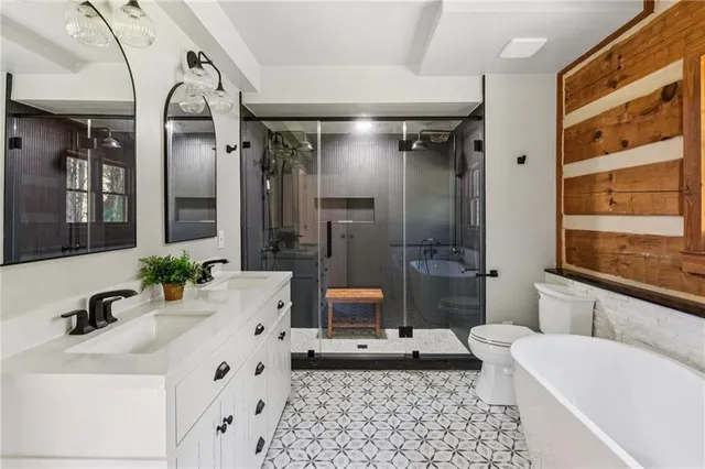 a bathroom with a double vanity sink toilet and shower