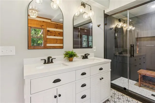 a bathroom with a sink double vanity and a mirror