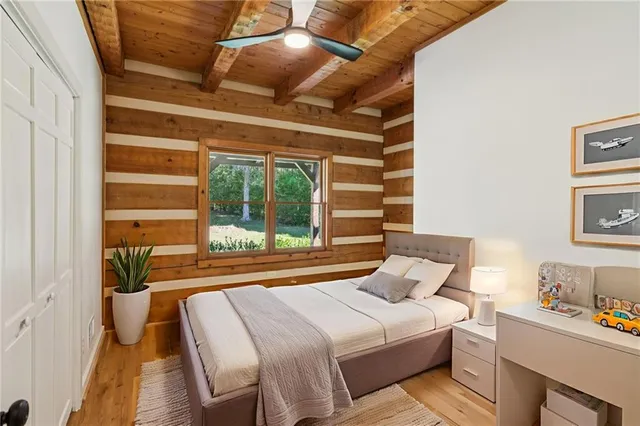 a bedroom with a bed and a large window with the outer view