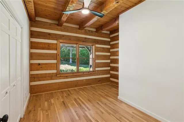a view of a room with wooden floor and windows