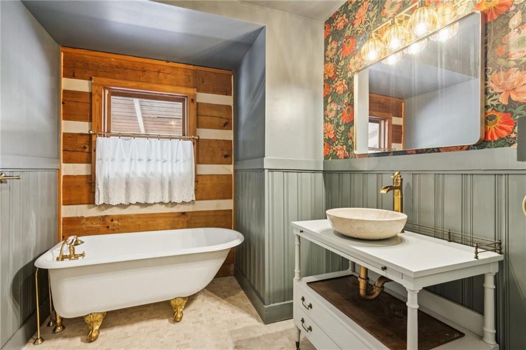 2905 Cammie Wages Road Dacula, GA 30019 - Photo 24 of 55 a bathroom with a sink a bathtub and a window