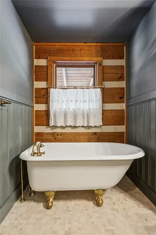 a bathroom with a bathtub and shower