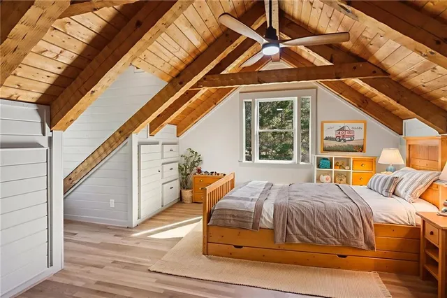 a bedroom with a bed next to a window