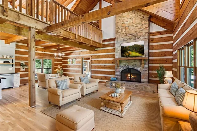 a view of a patio with couches table and chairs with wooden floor