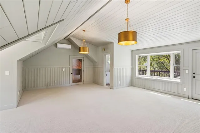 a spacious bedroom with a bed a couch and a window