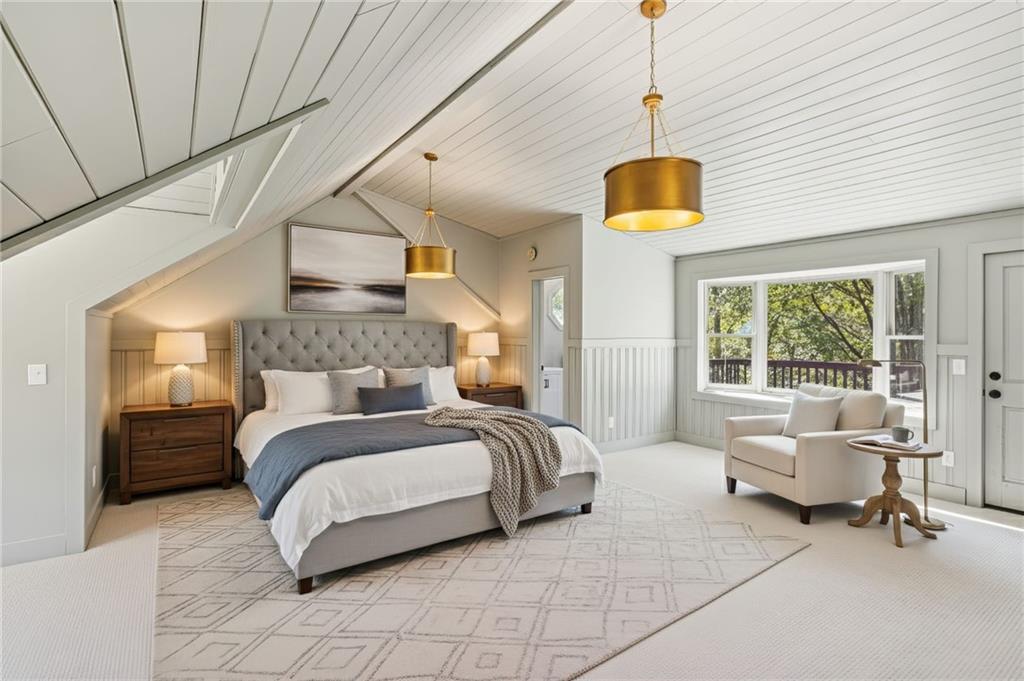 2905 Cammie Wages Road Dacula, GA 30019 - Photo 42 of 55 a spacious bedroom with a bed a couch and a window