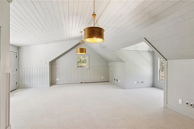 a view of empty room with a window and kitchen view