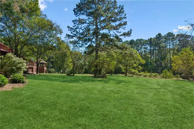a balcony with trees in front of it