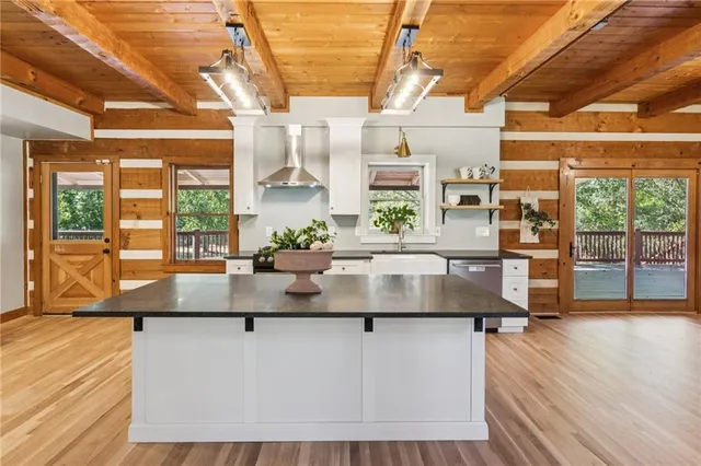 a kitchen with kitchen island a counter top space a large window and furniture