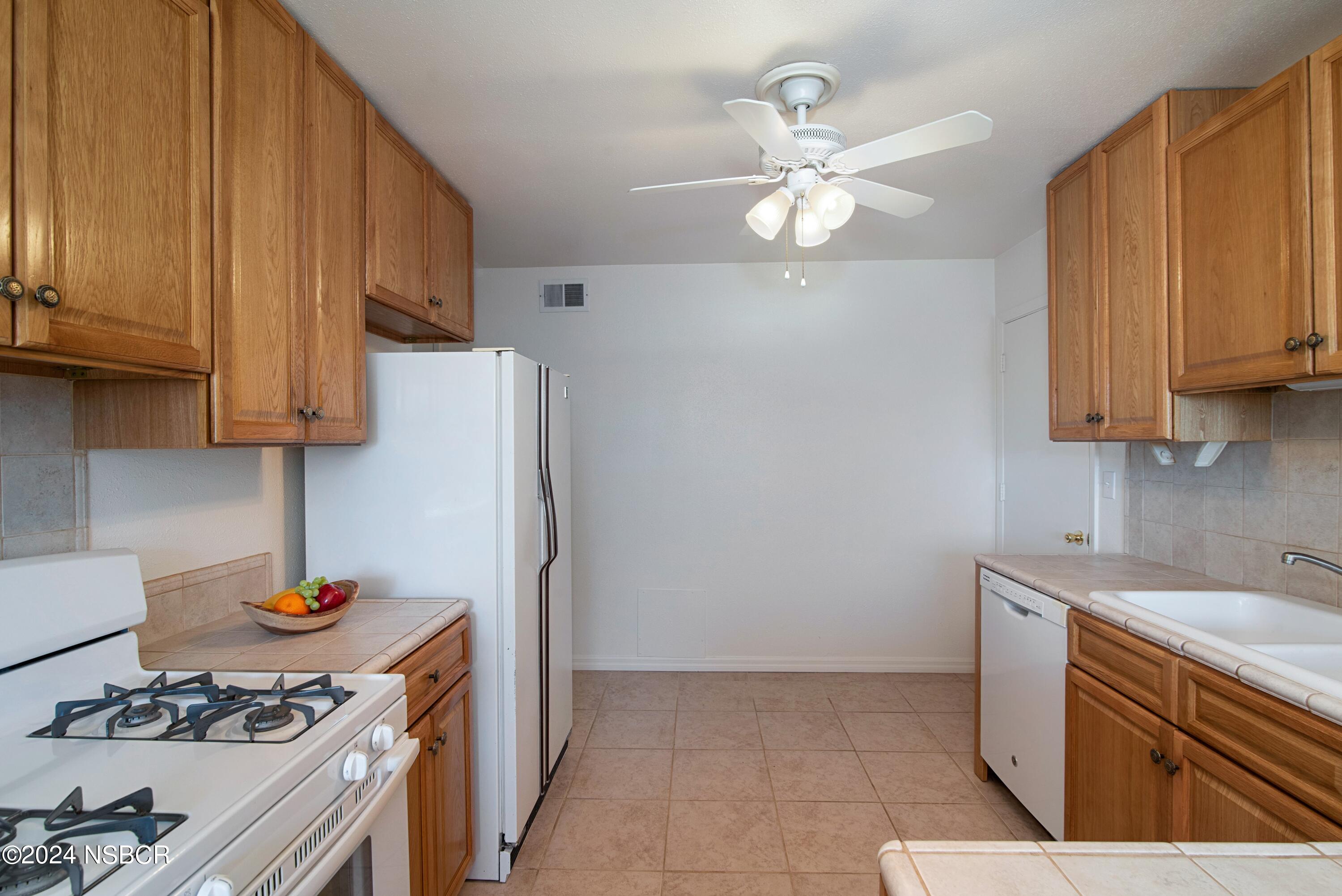 3380 Via Elba Lompoc, CA 93436 - Photo 7 of 23 a kitchen with stainless steel appliances a stove a sink and cabinets