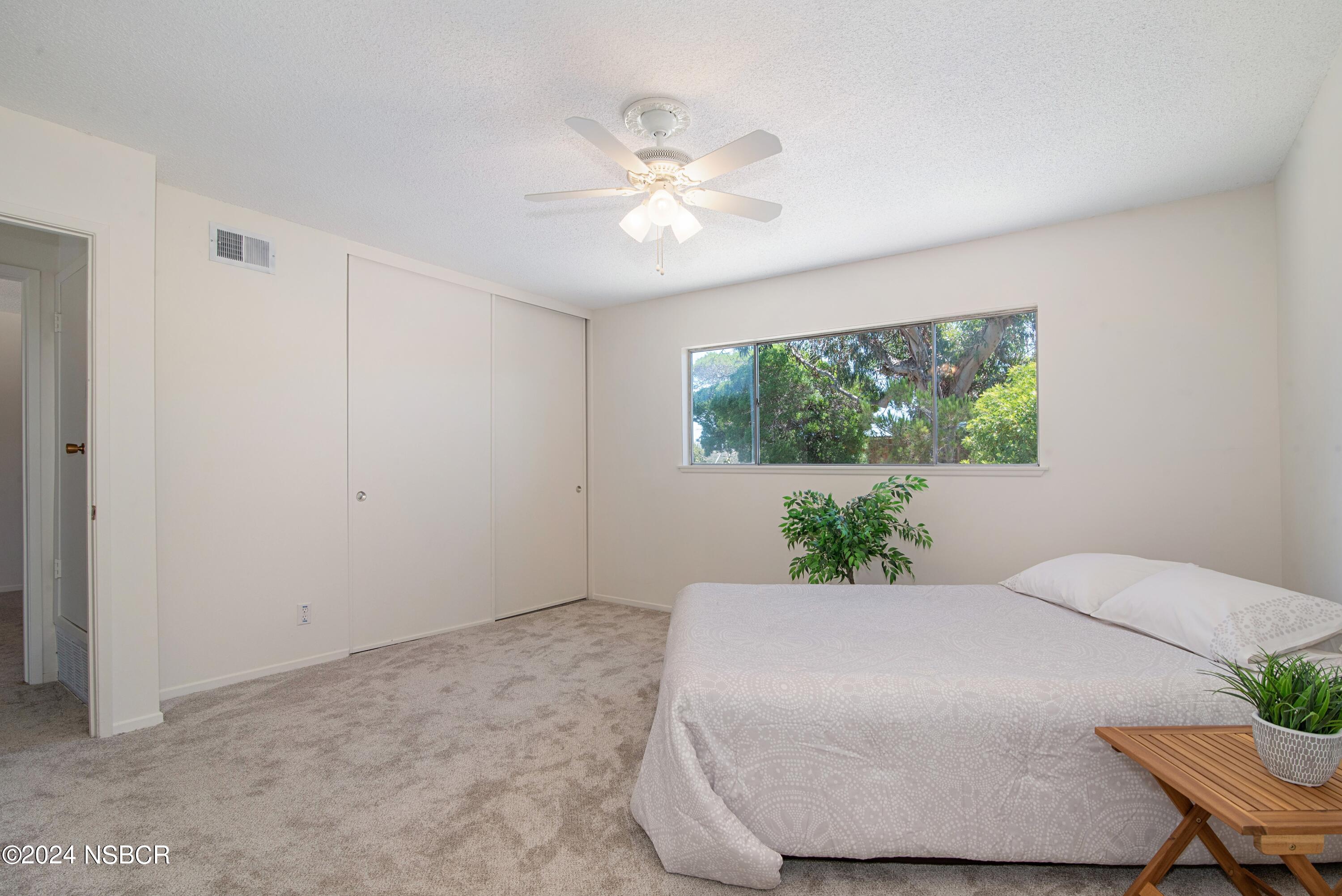 3380 Via Elba Lompoc, CA 93436 - Photo 9 of 23 a bedroom with a large bed and a chandelier