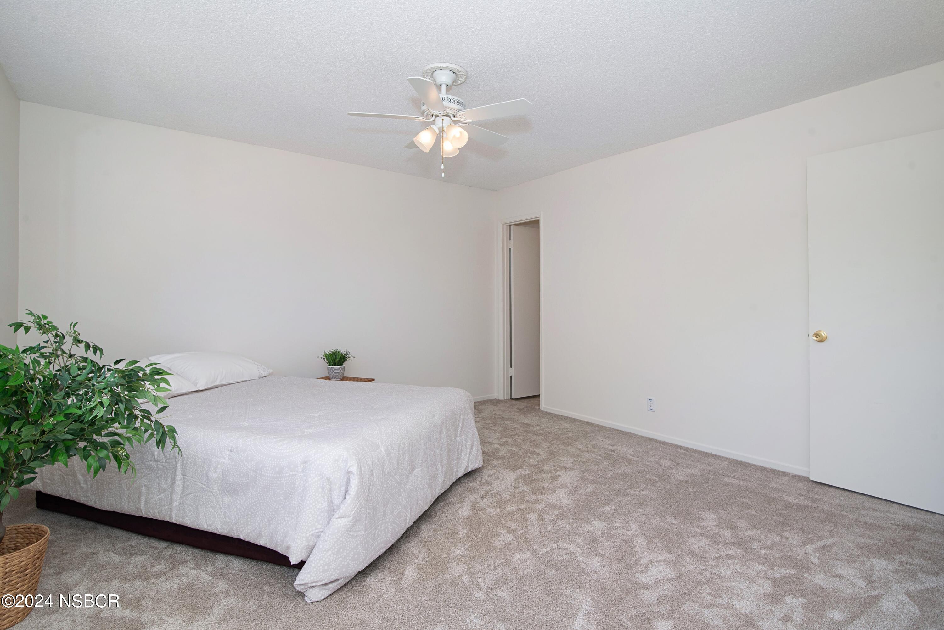 3380 Via Elba Lompoc, CA 93436 - Photo 10 of 23 a bed sitting in a bedroom and chandelier