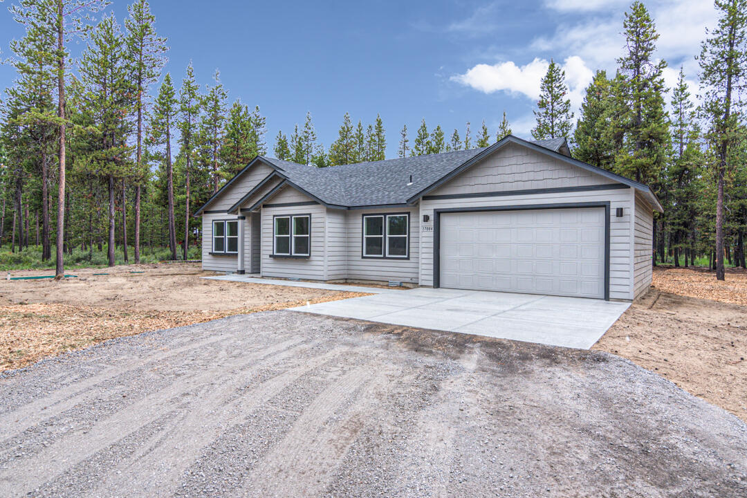 17084 Indio Road Bend, OR 97707 - Photo 5 of 40 a front view of a house with a yard and garage