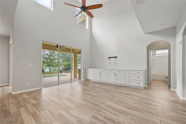 a view of a big room with closet and windows