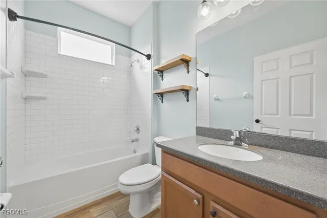 a view of kitchen with stainless steel appliances wooden floor and window