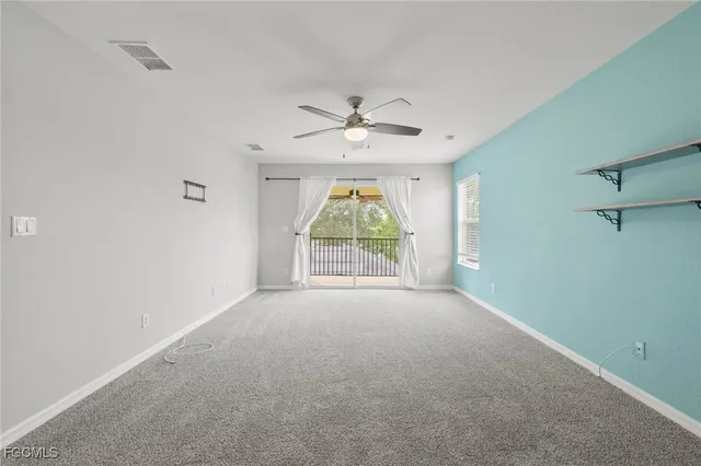 a view of a house with a big yard potted plants and large tree