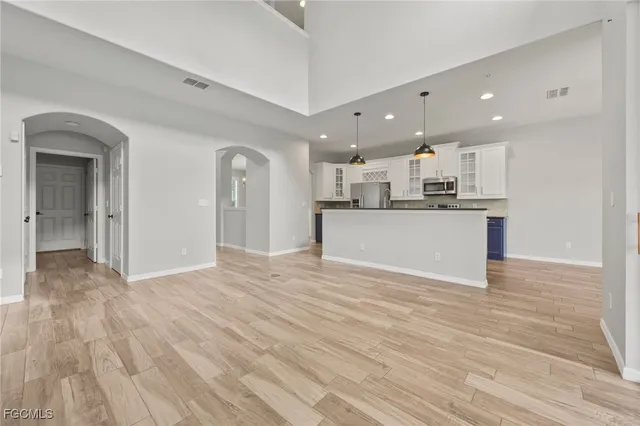 a view of wooden floor in an empty room with a window