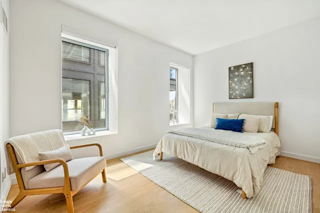 a spacious bedroom with a bed and a couch