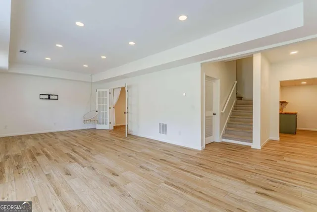 a view of a room with wooden floor and cabinet