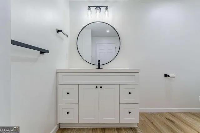 a view of a house with a yard and large tree