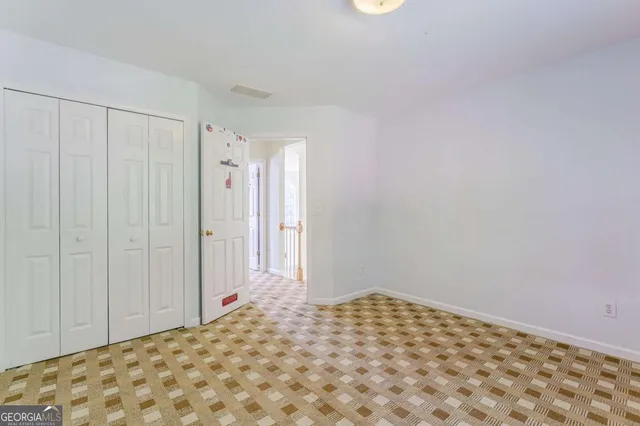 an aerial view of a house with outdoor space and trees all around