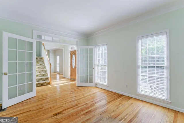 a view of a hallway with windows and plants
