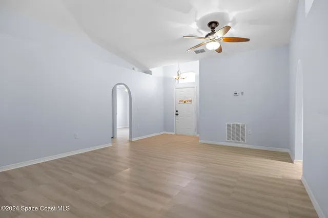 a view of a room with wooden floor and white walls