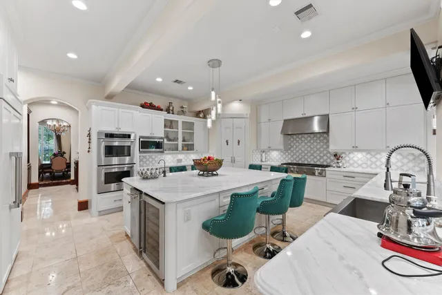 a kitchen with cabinets and stove top oven