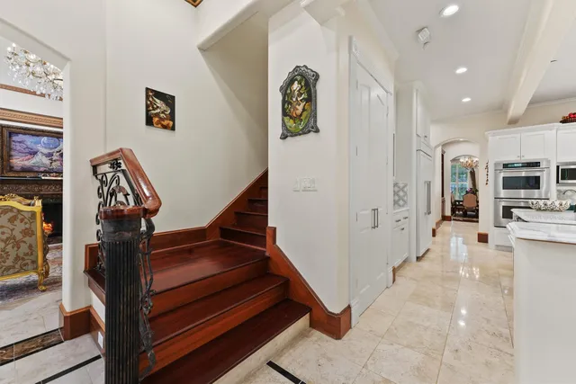a room with pool table windows and wooden floor