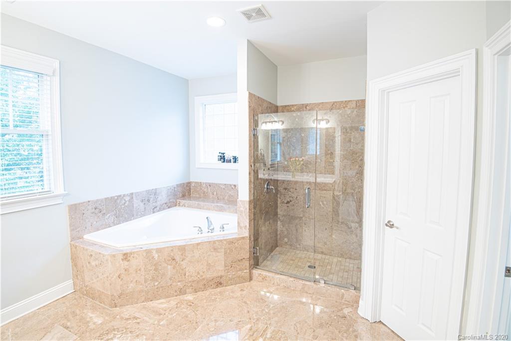 894 Promenade Walk Fort Mill, SC 29708 - Photo 22 of 45 a bathroom with a bathtub and a shower