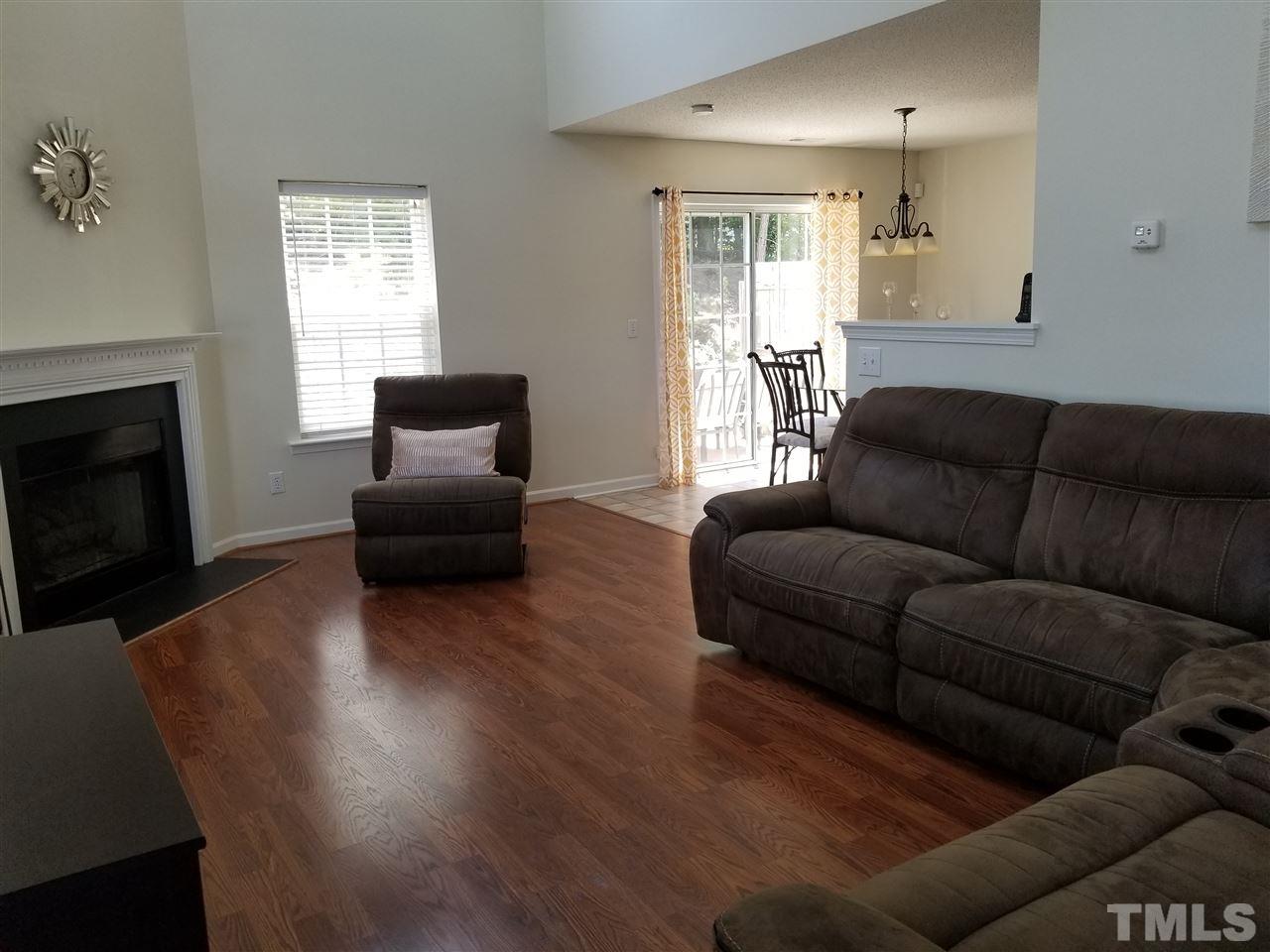 5832 Ricker Road Raleigh, NC 27610 - Photo 2 of 14 a living room with furniture and a fireplace