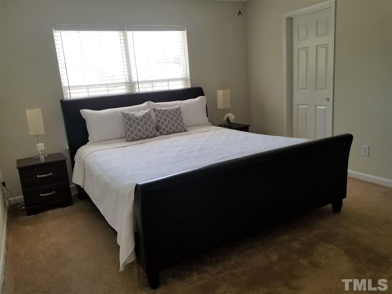 5832 Ricker Road Raleigh, NC 27610 - Photo 12 of 14 a bedroom with a bed and a window